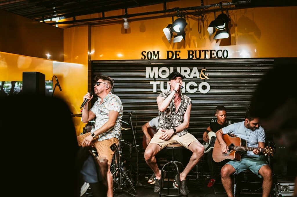 Vibrant live music performance featuring singers and guitarists in a bar.